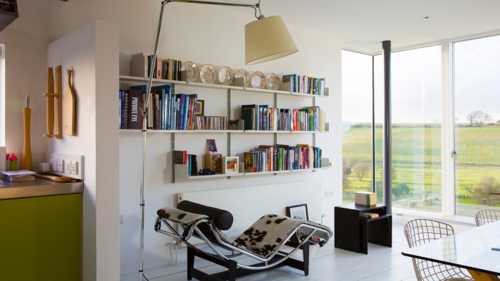 An invitingly open library above a radiator. Favourites picked out on the black 621 Side Table