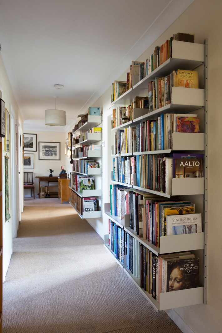 A narrow hallway easily accommodates a large library