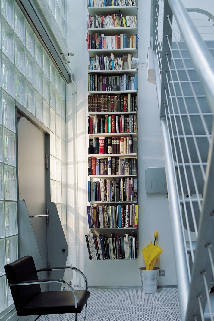 If your hallway is vertical rather than horizontal – and you have some stairs – your library can find a home