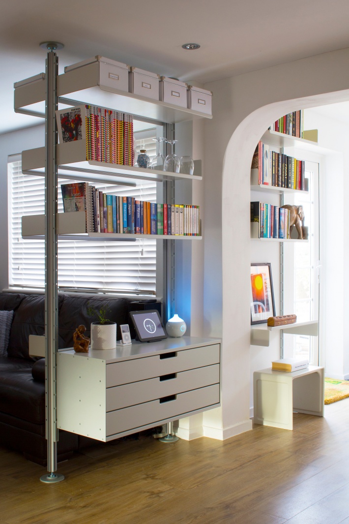 Hallway defined via a compressed shelving system. 621 Table is there-when-needed