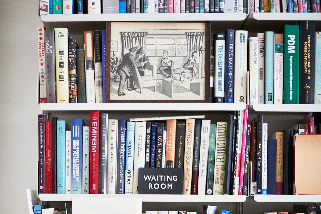 Alan’s mementoes in front of books on his Vitsoe 606 Universal Shelving System in New York