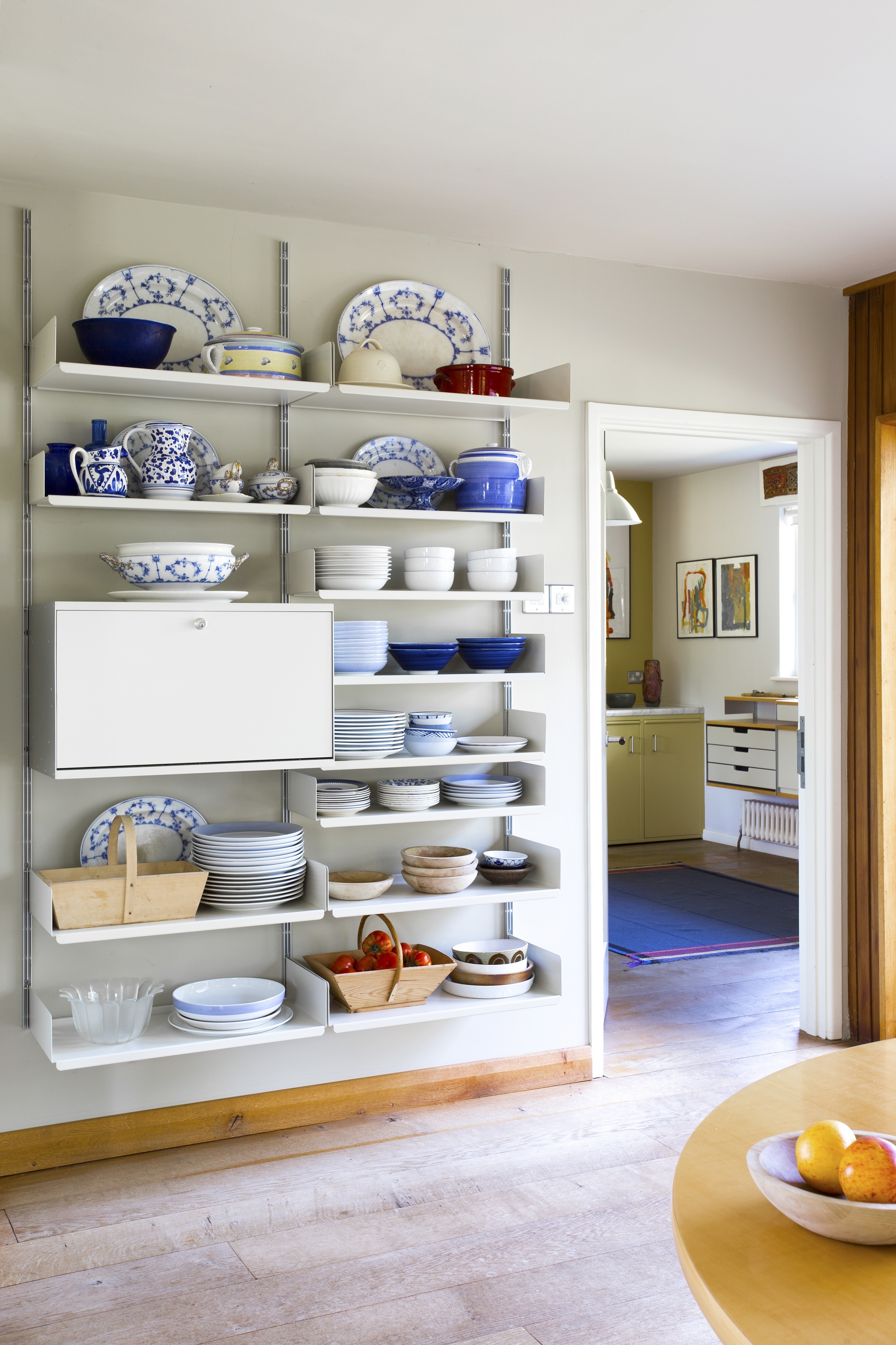Kitchen open shelving unit with cabinets, white, wall mounted, strong for heavy kitchenware. Modular Vitsœ 606 System. Designer shelves, Dieter Rams