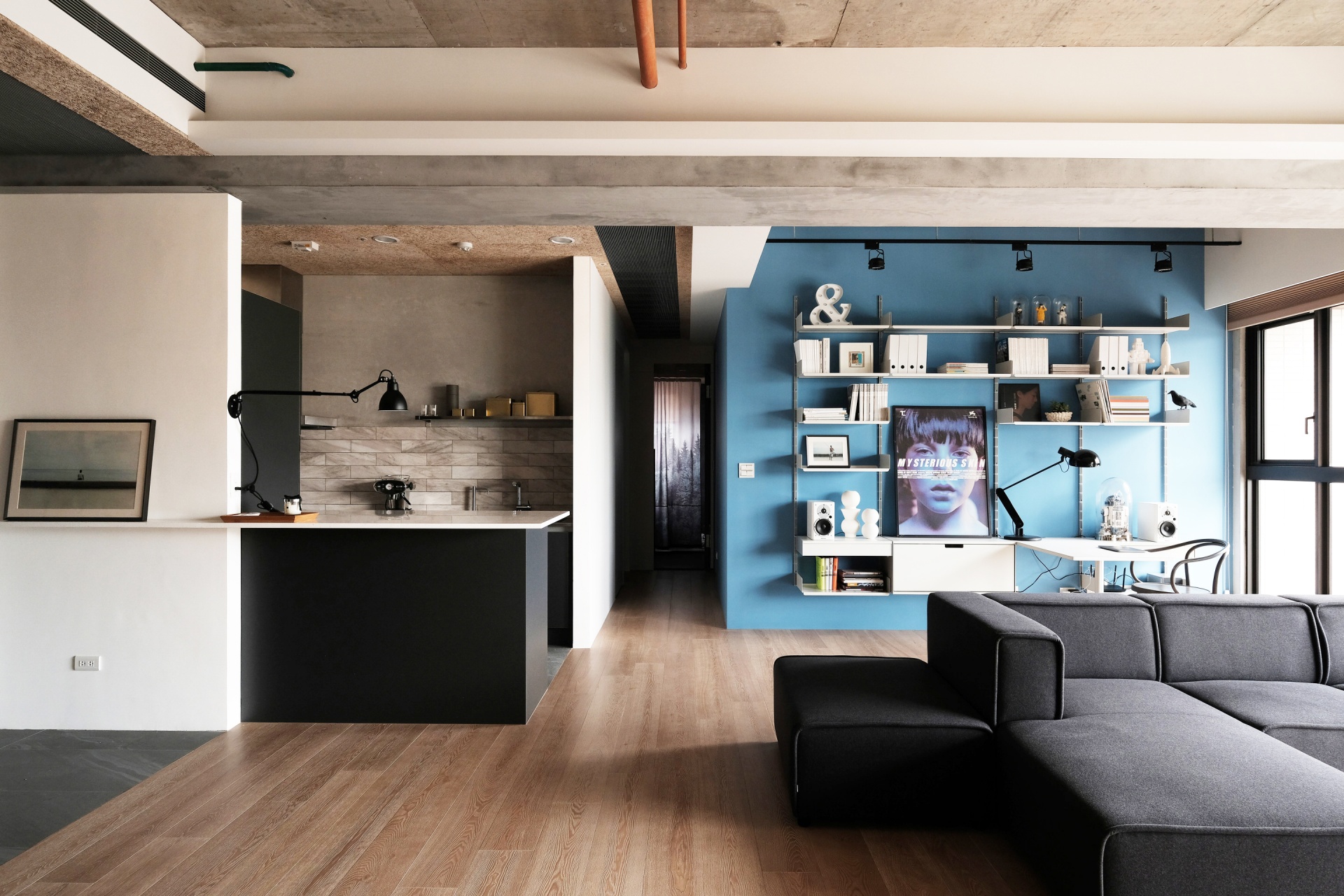 Home office set up with integrated desk table and shelves above for books, box file storage in Living room. Wall mounted, off-white. Vitsœ Modular 606 Universal Shelving System. Designer shelves, Dieter Rams