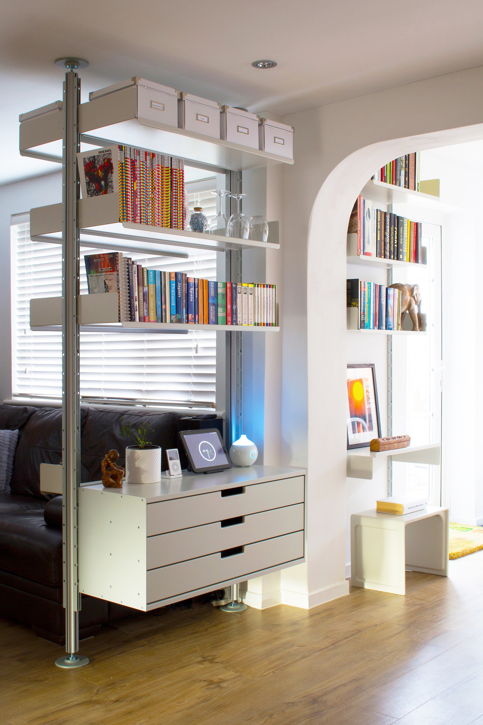 Modern floor to ceiling bookshelves and storage drawer cabinets. Hallway. 606 Modular Shelving System. Side table 621. Designer, Dieter Rams. Vitsœ
