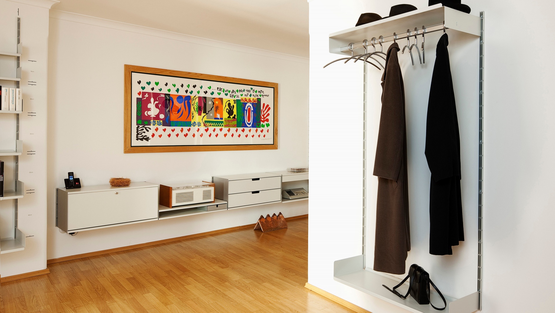 Modern hallway open wardrobe shelving. Clothes rail shelves. Sideboard floating cabinets for display, and storage. 606 Modular Shelving System. Designer, Dieter Rams. Vitsœ