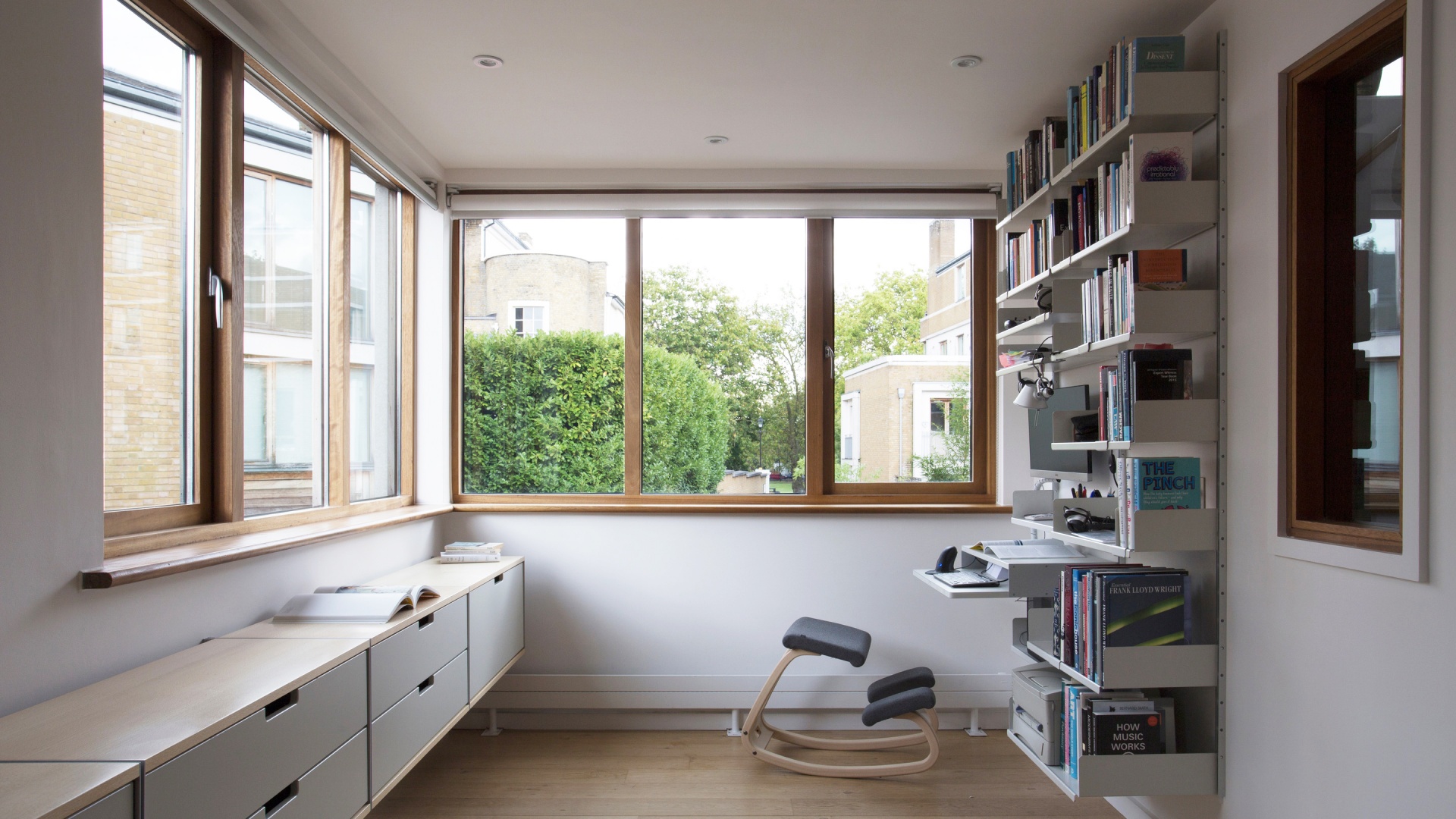 Modular Shelving system with desk and strong shelves for heavy books and box file storage. Above desk modular shelving unit, wall-mounted bookshelves for modern home office/study room. Beech and off-white sideboard cabinets. Designer shelves, Dieter Rams. Vitsœ 606 Universal Shelving System.