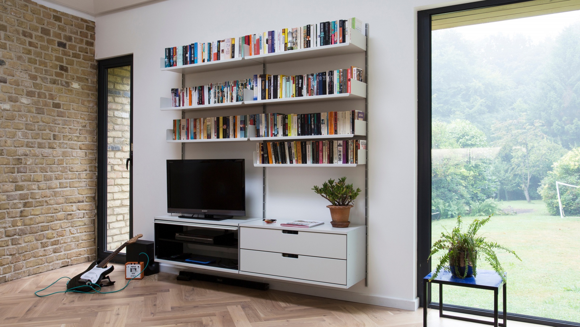 TV stand sideboard cabinets. Entertainment center. Modern modular 606 shelving system with strong designer shelves for book collection. Designer Dieter Rams. Vitsœ.