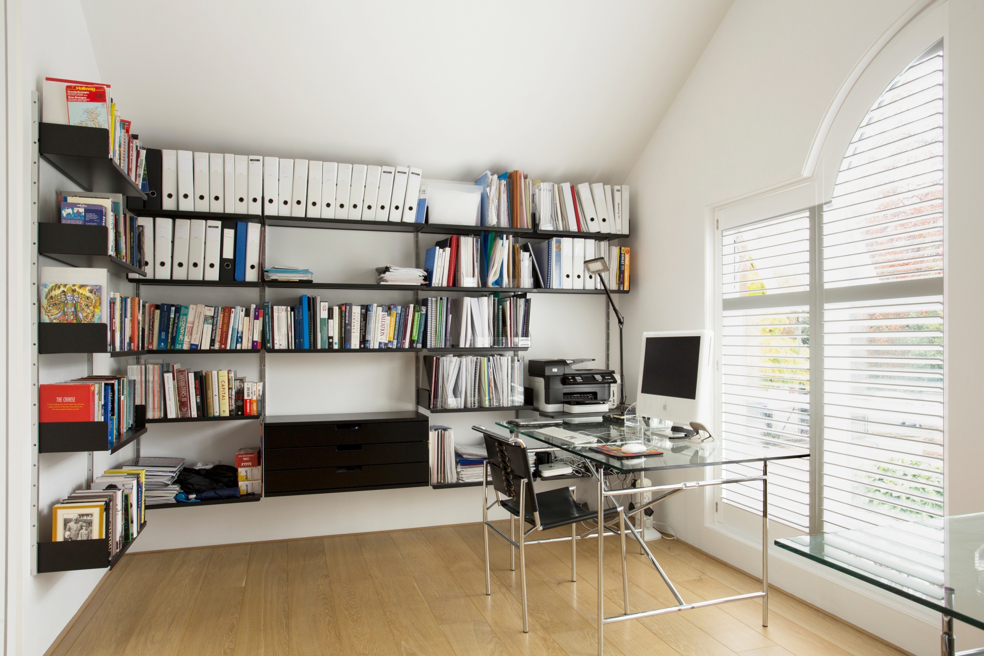 live work space design. Office open shelving and lockable cabinet, black. metal shelves 30 cm for filing, wall bookshelves. Modular shelving system, Vitsœ 606,  designer shelves Dieter Rams.
