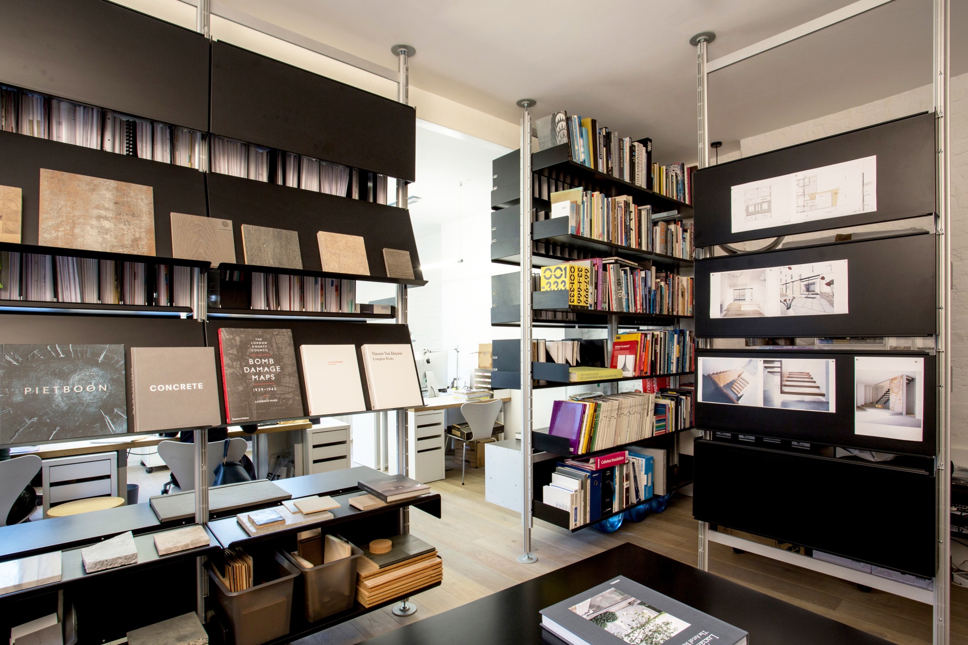 Compression shelving system, office room dividers. Floor to ceiling. Modern office interiors. 30cm filing shelves, sloping shelves for display. Lockable cabinets. Vitsœ 606 modular shelving system. Designer shelves Dieter Rams.