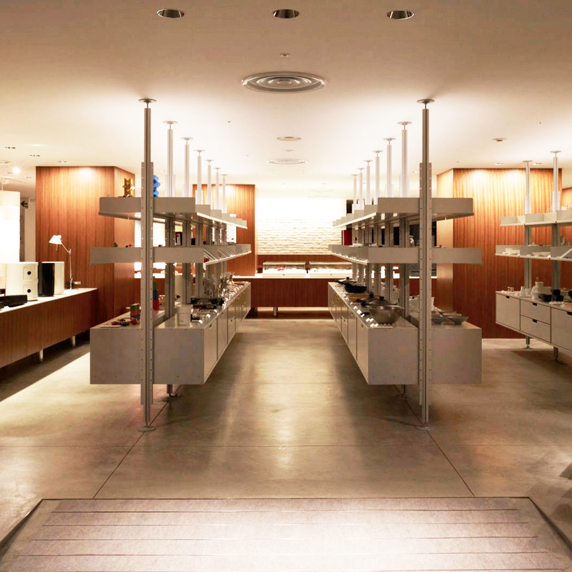 Modern shop display shelving and drawer cabinets, floor to ceiling compressed system. Museum store. Vitsœ 606 Universal Modular Shelving System. Design Dieter Rams