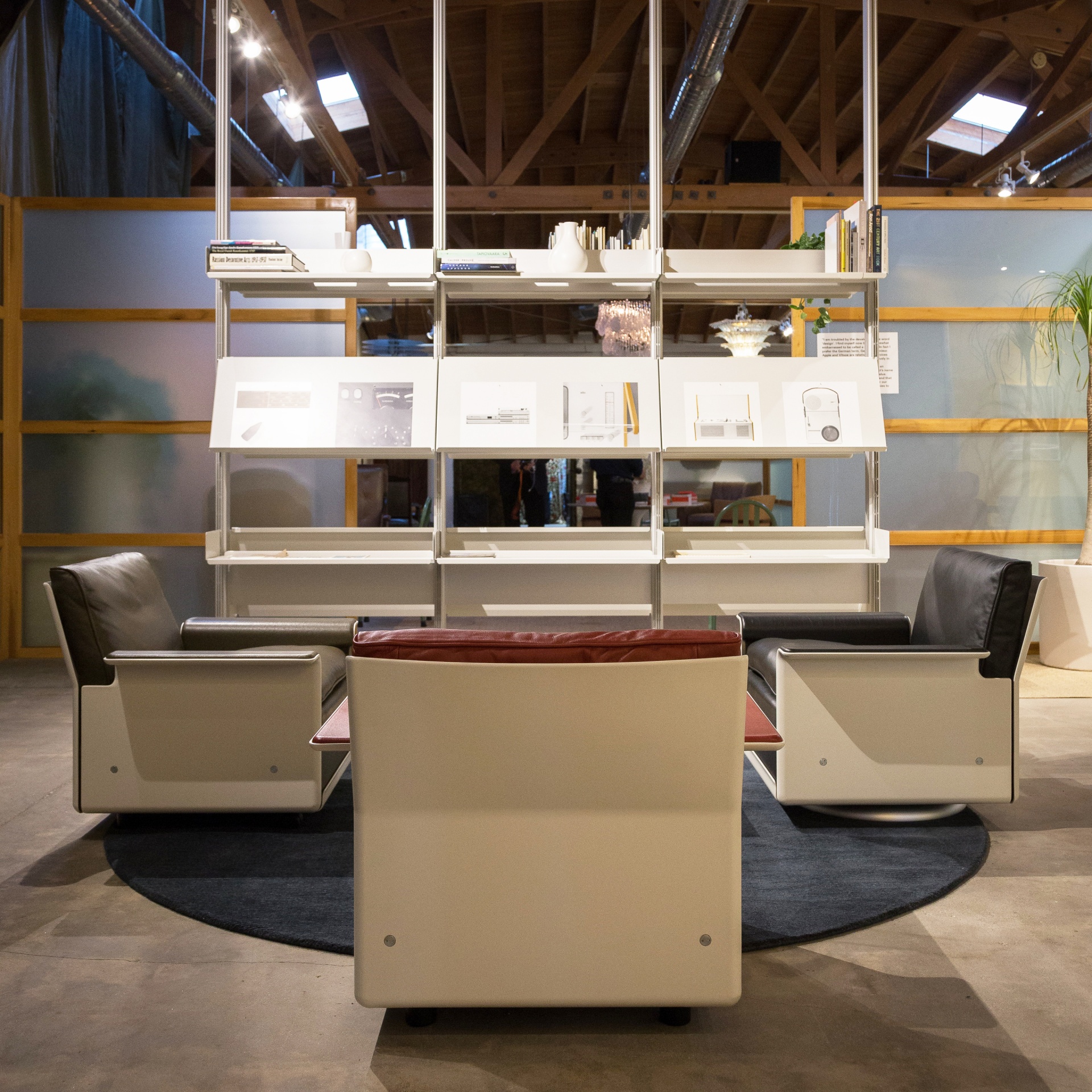 Museum display. Dieter Rams exhibition. 606 off-white system, 620 Chair low back in leather. Modular Vitsœ 606 Universal Shelving System. Design Dieter Rams