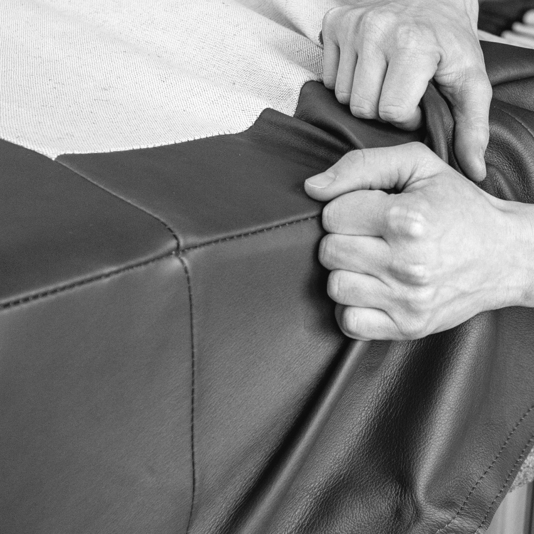 Lounge chair or sofa replacing upholstery demonstration. Replacement of linen and leather upholstery is available for designer 620 Chair Programme