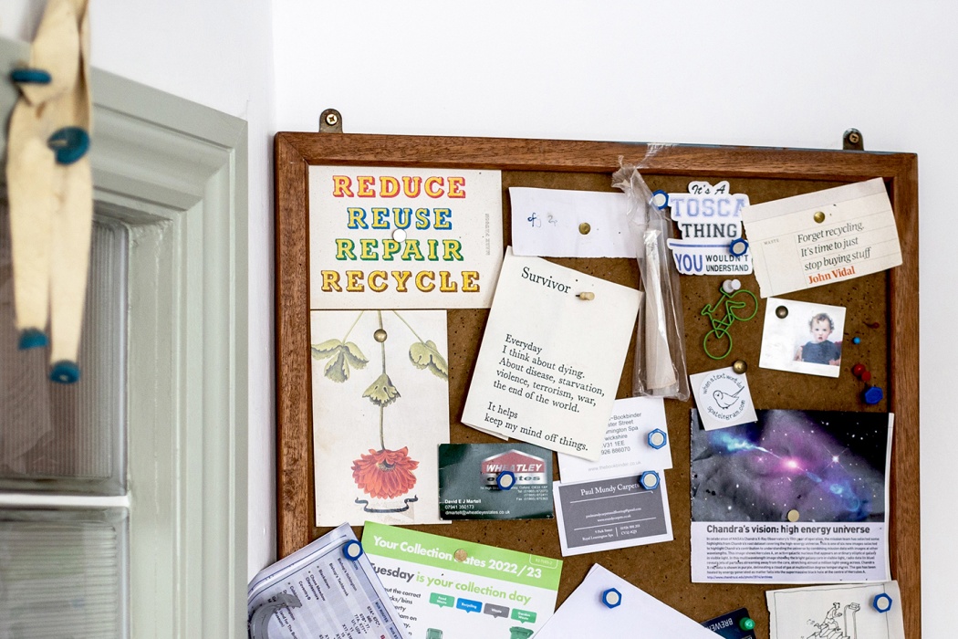 Pinboard with sign saying ’Forget recycling, it’s time to just stop buying stuff‘, top right