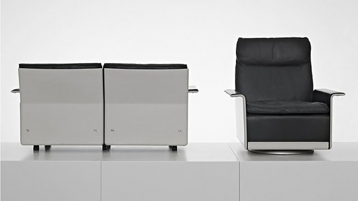 High-back 620 Chair  and two-seater sofa from the back in an exhibition